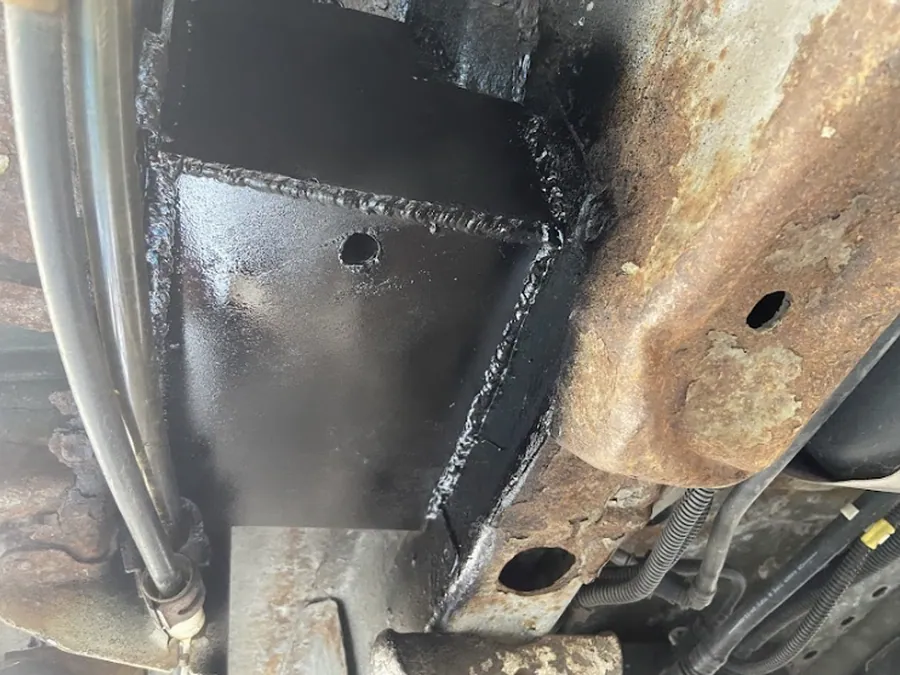 New steel plate welded in and coated where a trailing arm mount had rusted out